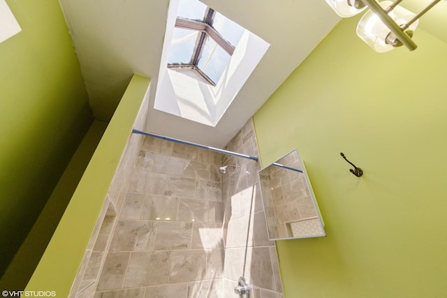 4747 W Monroe St, Chicago, IL 60644 - full bathroom featuring tiled shower, a skylight, and lofted ceiling