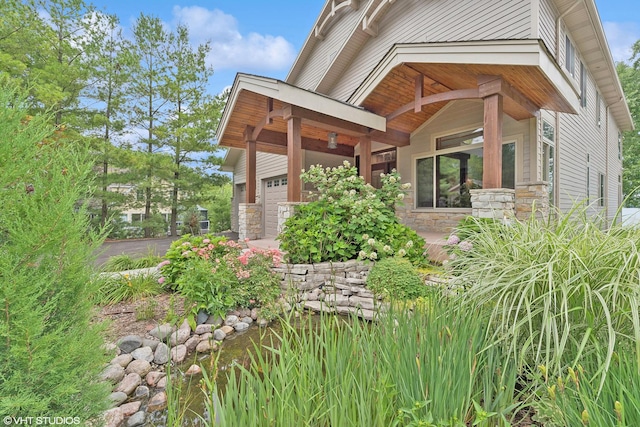 250 Whitney Rd, Lake Zurich, IL 60047 - view of home's exterior with stone siding, an attached garage, and driveway