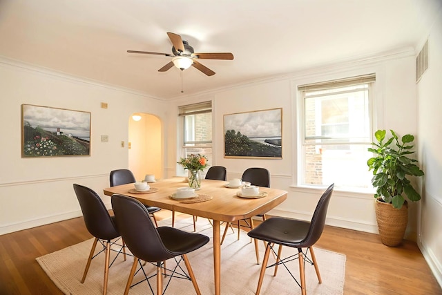 6048 N Rockwell Ave Unit 2, Chicago, IL 60659 - dining space with arched walkways, light wood finished floors, crown molding, and ceiling fan