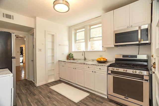 6048 N Rockwell Ave Unit 2, Chicago, IL 60659 - kitchen with appliances with stainless steel finishes, white cabinetry, dark wood finished floors, and light stone counters