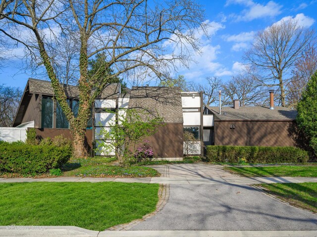 view of front of home with a front yard and stucco siding