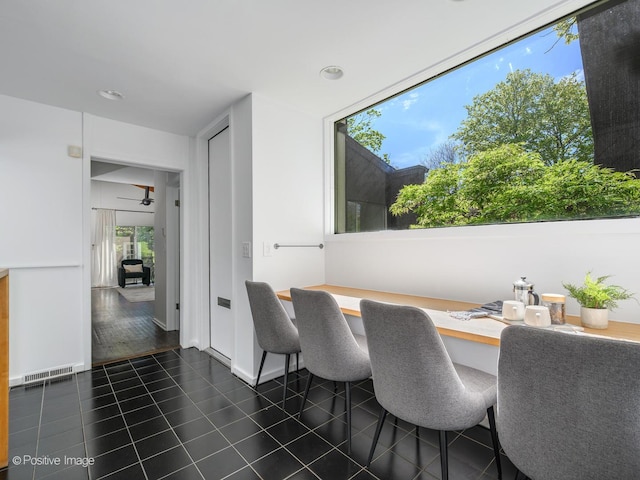 dining room with dark tile patterned floors