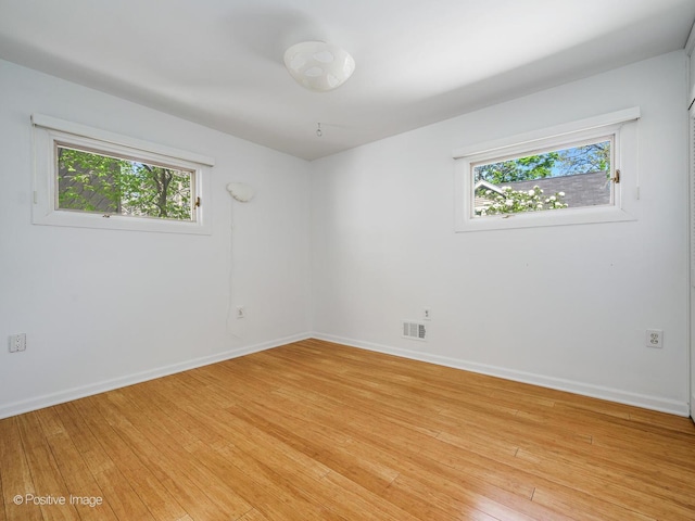 empty room with light wood-type flooring and baseboards
