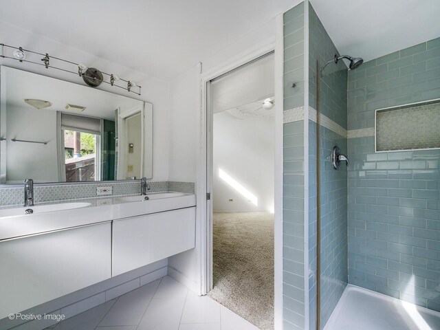full bathroom featuring a stall shower, tile patterned floors, and double vanity