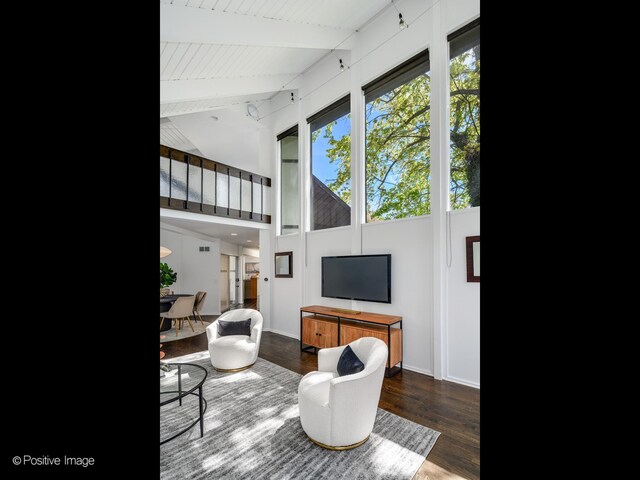 living room with wood finished floors, beam ceiling, baseboards, high vaulted ceiling, and wood ceiling