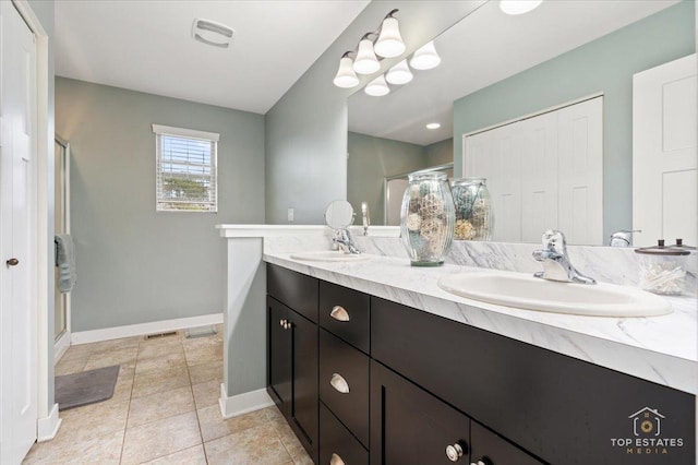 1308 Burry St, Joliet, IL 60435 - bathroom featuring baseboards, double vanity, a stall shower, and tile patterned floors