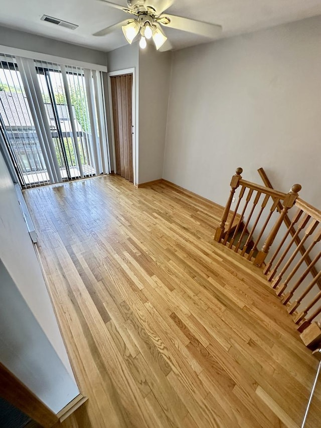 35 Montego Colony Unit 1, Fox Lake, IL 60020 - unfurnished living room with light wood finished floors and a ceiling fan