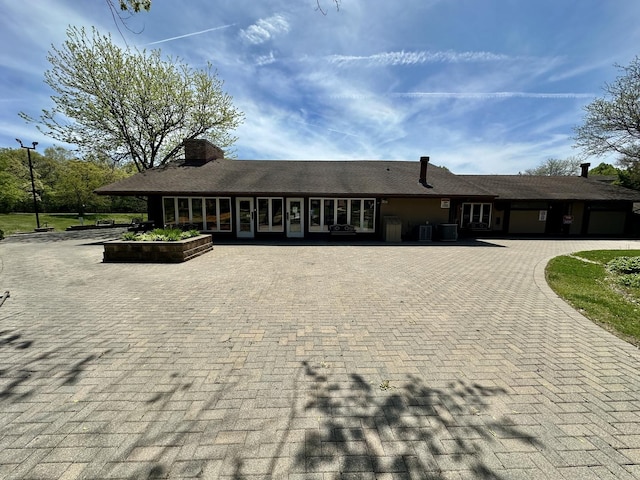 35 Montego Colony Unit 1, Fox Lake, IL 60020 - view of front of property featuring curved driveway, a chimney, and cooling unit