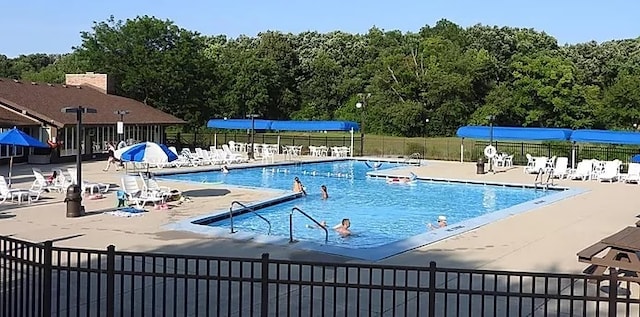 35 Montego Colony Unit 1, Fox Lake, IL 60020 - community pool featuring a patio area, fence, and a forest view