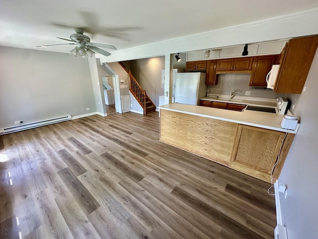 35 Montego Colony Unit 1, Fox Lake, IL 60020 - kitchen featuring white appliances, ceiling fan, light countertops, a peninsula, and wood finished floors