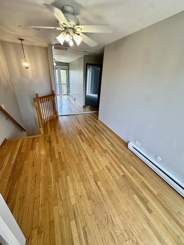 35 Montego Colony Unit 1, Fox Lake, IL 60020 - spare room featuring a baseboard heating unit, light wood-style flooring, and a ceiling fan
