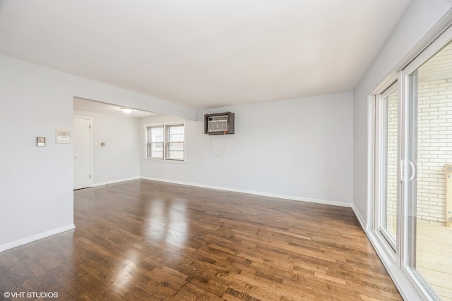 5747 S Kenton Ave Unit 3S, Chicago, IL 60629 - unfurnished room with a wall mounted air conditioner, wood finished floors, and baseboards