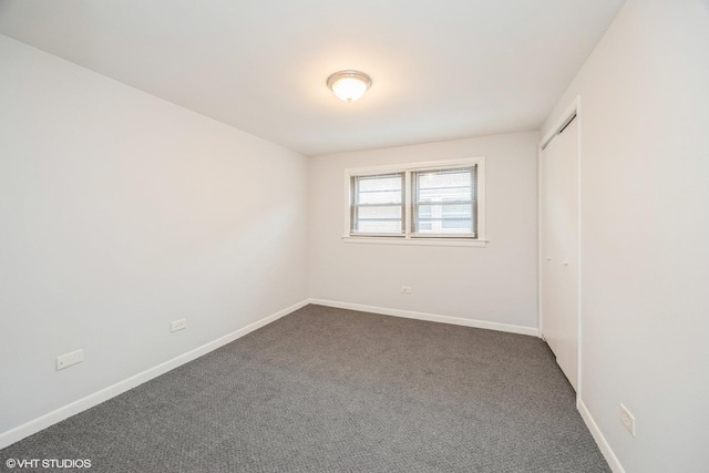 5747 S Kenton Ave Unit 3S, Chicago, IL 60629 - unfurnished bedroom with dark carpet, baseboards, and a closet