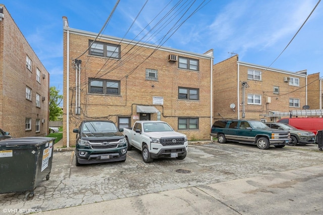 5747 S Kenton Ave Unit 3S, Chicago, IL 60629 - view of building exterior with uncovered parking and a wall mounted AC