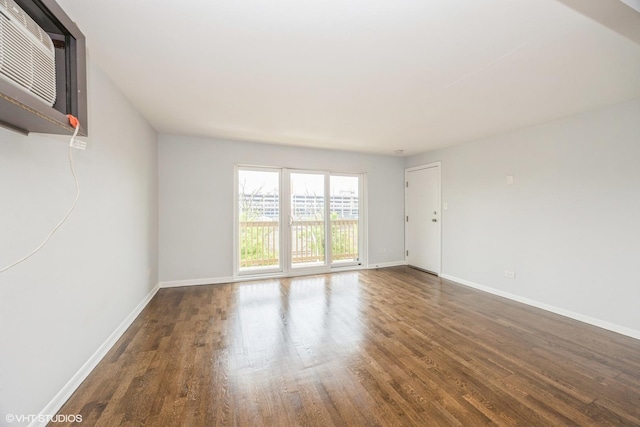 5747 S Kenton Ave Unit 3S, Chicago, IL 60629 - spare room with wood finished floors, a wall mounted air conditioner, and baseboards