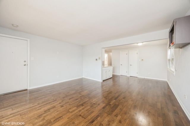 5747 S Kenton Ave Unit 3S, Chicago, IL 60629 - unfurnished living room with dark wood-style floors and baseboards