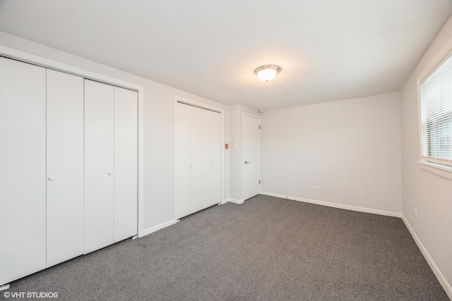 5747 S Kenton Ave Unit 3S, Chicago, IL 60629 - unfurnished bedroom with multiple closets, carpet floors, and baseboards