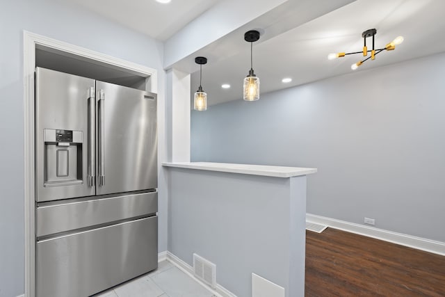 715 E 105th Pl, Chicago, IL 60628 - kitchen with stainless steel fridge with ice dispenser, baseboards, recessed lighting, light countertops, and a peninsula