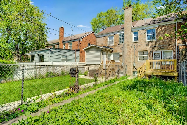 715 E 105th Pl, Chicago, IL 60628 - rear view of property with brick siding, a chimney, and a wooden deck