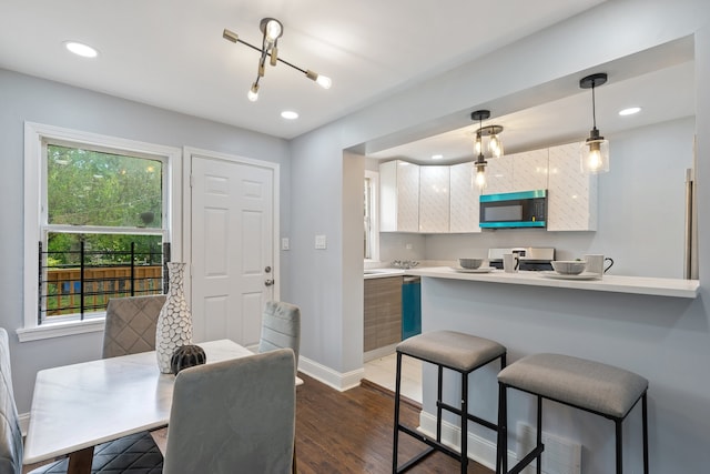 715 E 105th Pl, Chicago, IL 60628 - kitchen with stainless steel electric range, a kitchen bar, healthy amount of natural light, light countertops, and recessed lighting
