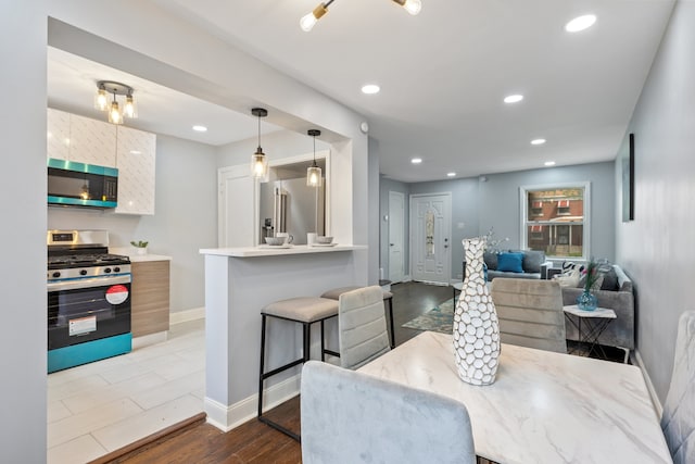 715 E 105th Pl, Chicago, IL 60628 - dining space featuring baseboards, recessed lighting, and dark wood-style flooring