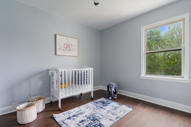 715 E 105th Pl, Chicago, IL 60628 - bedroom featuring baseboards, wood finished floors, and a nursery area