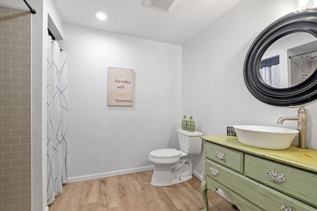 9051 Mansfield Dr, Tinley Park, IL 60487 - full bath featuring wood finished floors, vanity, toilet, a shower with shower curtain, and baseboards