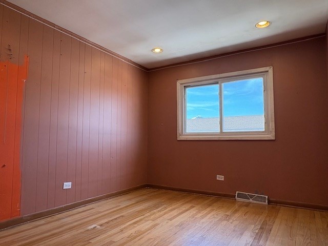 9865 Garden Ct, Schiller Park, IL 60176 - unfurnished room featuring light wood-style floors, baseboards, recessed lighting, and wood walls