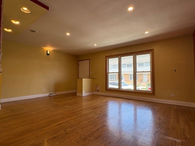 9865 Garden Ct, Schiller Park, IL 60176 - spare room featuring wood finished floors, baseboards, and recessed lighting