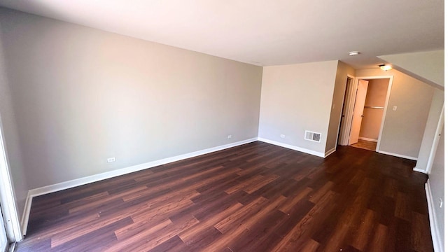 unfurnished room featuring dark wood-style floors and baseboards