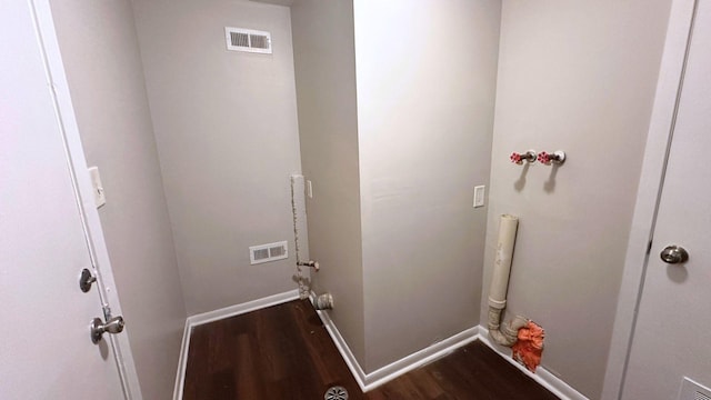 washroom with dark wood-style floors and baseboards