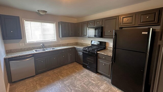 kitchen with black appliances, a sink, and light countertops