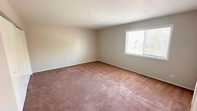 unfurnished bedroom with carpet flooring, a closet, and baseboards