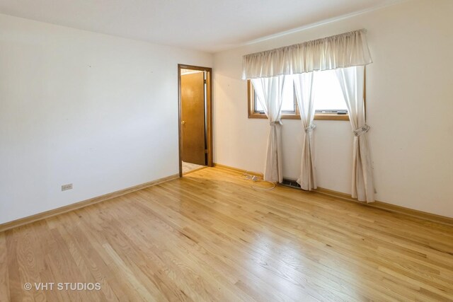 1527 W Amelia Ln, Addison, IL 60101 - empty room with light wood-style floors and baseboards