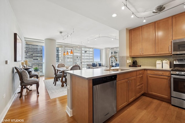 250 E Pearson St Unit 1306, Chicago, IL 60611 - kitchen with appliances with stainless steel finishes, track lighting, a sink, and light wood finished floors