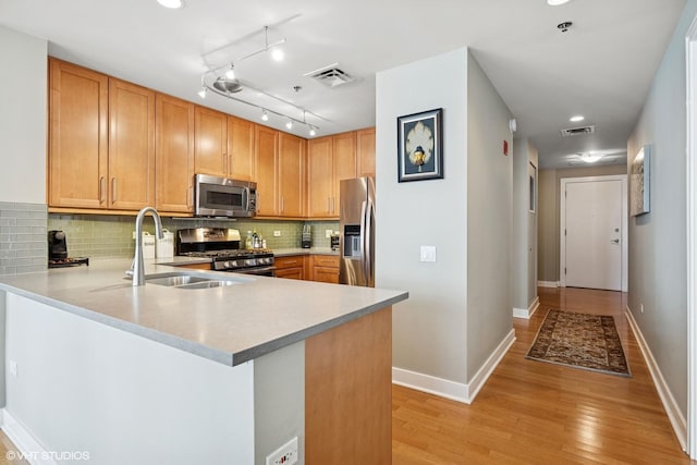 250 E Pearson St Unit 1306, Chicago, IL 60611 - kitchen with appliances with stainless steel finishes, a sink, light wood-style floors, light countertops, and recessed lighting