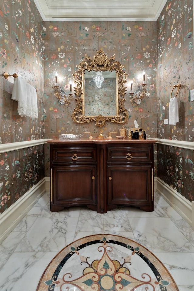 65 E Goethe St Unit 4N, Chicago, IL 60610 - bathroom with ornamental molding, marble tiled floors, wallpapered walls, vanity, and baseboards