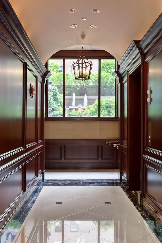 65 E Goethe St Unit 4N, Chicago, IL 60610 - detailed view of a chandelier, arched walkways, recessed lighting, inlaid floor details, and a decorative wall