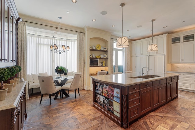 65 E Goethe St Unit 4N, Chicago, IL 60610 - kitchen featuring a sink, open shelves, a chandelier, glass insert cabinets, and light stone countertops