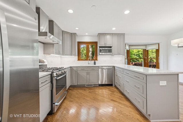 4222 Black Oak Dr, Lisle, IL 60532 - kitchen with stainless steel appliances, gray cabinets, a peninsula, wall chimney exhaust hood, and recessed lighting