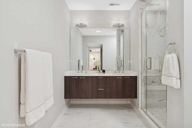 921 N Hoyne Ave Unit 1, Chicago, IL 60622 - bathroom featuring marble look tiles, a marble finish shower, baseboards, and double vanity