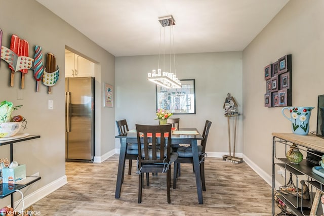 100 Lake Blvd Unit 646, Buffalo Grove, IL 60089 - dining space with a chandelier, light wood-style floors, and baseboards
