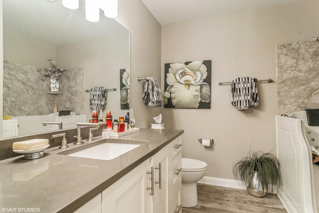 100 Lake Blvd Unit 646, Buffalo Grove, IL 60089 - bathroom with wood finished floors, vanity, toilet, and baseboards