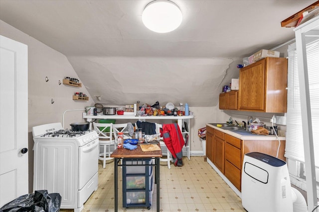 401 S Maple St, Urbana, IL 61801 - kitchen with white range with gas cooktop, light floors, brown cabinetry, lofted ceiling, and light countertops