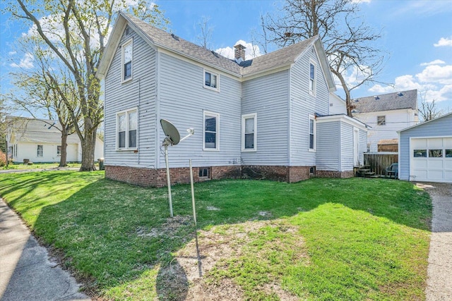 401 S Maple St, Urbana, IL 61801 - view of side of property with a yard, a chimney, an outdoor structure, a garage, and roof with shingles