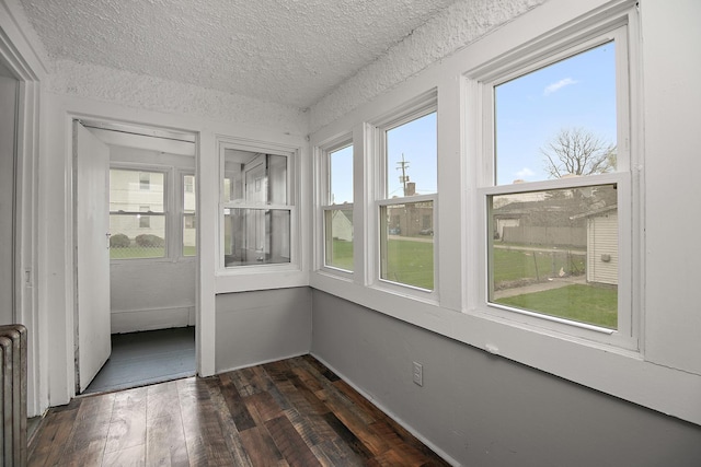 152 S Greenwood Ave, Kankakee, IL 60901 - unfurnished sunroom with a textured ceiling and hardwood / wood-style floors
