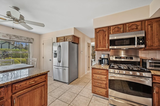 1251 Country Ln, Deerfield, IL 60015 - kitchen with stainless steel appliances, tasteful backsplash, ceiling fan, and light stone countertops