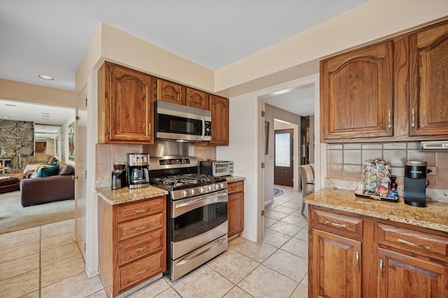 1251 Country Ln, Deerfield, IL 60015 - kitchen with stainless steel appliances, light tile patterned floors, backsplash, brown cabinets, and recessed lighting