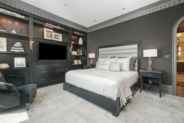 bedroom with arched walkways and ensuite bathroom
