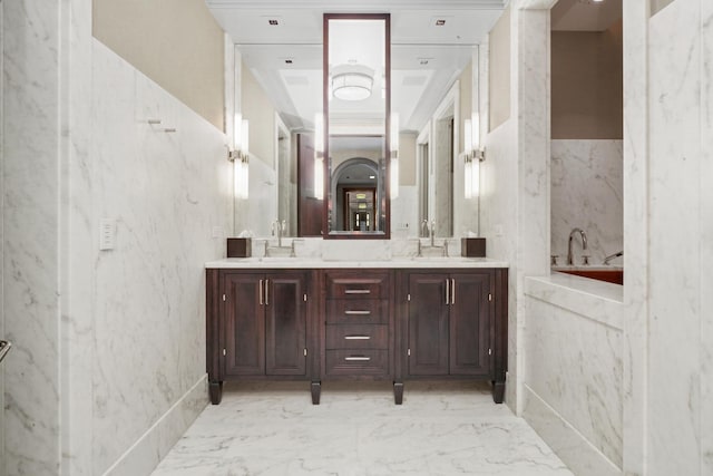 bathroom with marble finish floors, double vanity, and a tub with marble appearance